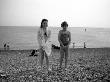 Two Little Girls Pose For Their Photo On A Pebbly Brighton Beach by Vanessa Wagstaff Limited Edition Print