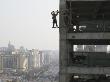 Construction Worker Hangs Off Side Of Cyts Hq Under Construction In Dongzhimen, Central Beijing by Ben Mcmillan Limited Edition Print