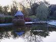 Summerhouse, Wooden Bridge Across Pool In Winter With Cornus And Tree Reflections, Duncan Heather by Clive Nichols Limited Edition Print