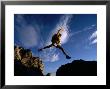 Hiker Jumping Between Rocks In The Wasatch Mountains, Wasatch-Cache National Forest, Utah, Usa by Cheyenne Rouse Limited Edition Print