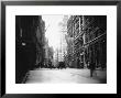 People And Horse Drawn Carts On Wall St, Where American Flags Fly From Buildings by George B. Brainerd Limited Edition Print