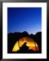 Camper Reading By Lantern In Tent At Dusk, Yosemite National Park, Usa by Woods Wheatcroft Limited Edition Print