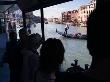 Visitors Wait At A Vaporetto Stop And Watch Gondoliers In Grand Canal, Venice, Italy by Robert Eighmie Limited Edition Print