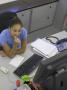 Office Life And Interiors, Young Woman At Desk Looking At Screen And Biting Her Nail by Richard Bryant Limited Edition Print