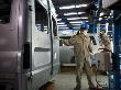 Workers Move Vehicles Along The Assembly Line At Ford Vietnam by Steve Raymer Limited Edition Print